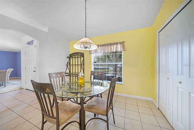 dining room with light tile patterned flooring and an inviting chandelier