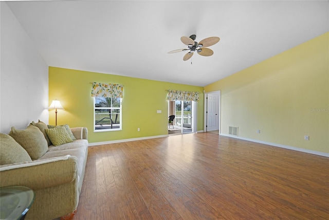 unfurnished living room featuring hardwood / wood-style floors, vaulted ceiling, and ceiling fan