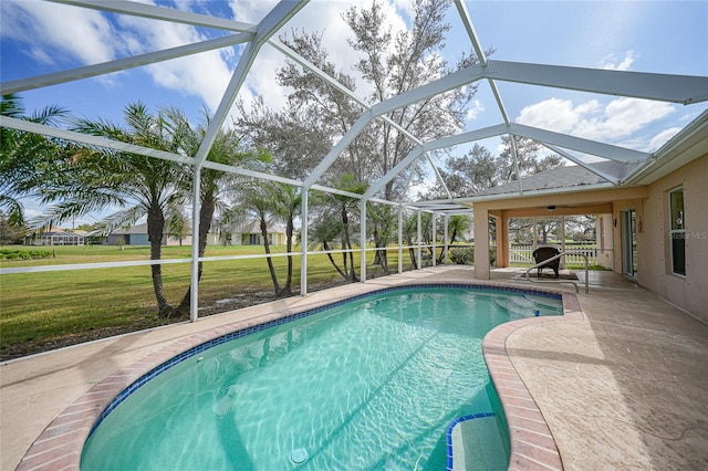 view of swimming pool with a patio, a lawn, and a lanai