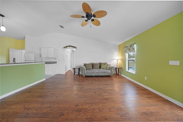 unfurnished living room featuring ceiling fan, vaulted ceiling, and dark hardwood / wood-style flooring