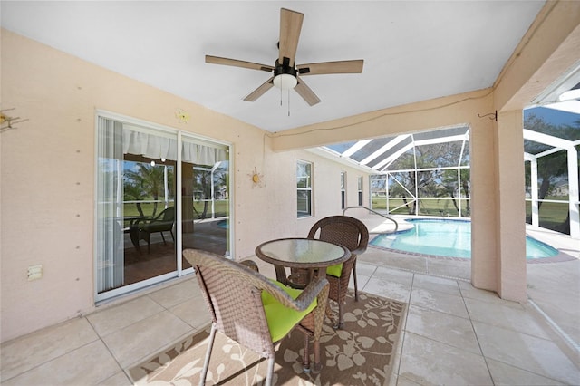 view of patio featuring ceiling fan and a lanai