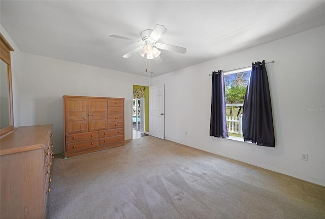 unfurnished bedroom featuring carpet floors and ceiling fan