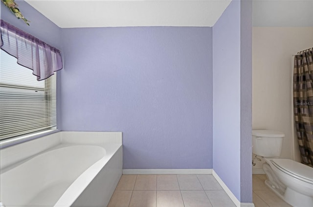 bathroom with toilet, tile patterned floors, and a bathtub