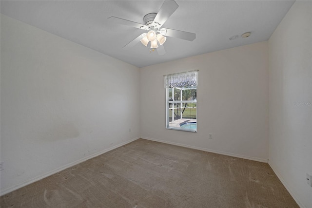 spare room with light carpet and ceiling fan