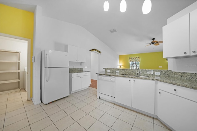 kitchen with white appliances, sink, white cabinetry, vaulted ceiling, and light stone counters