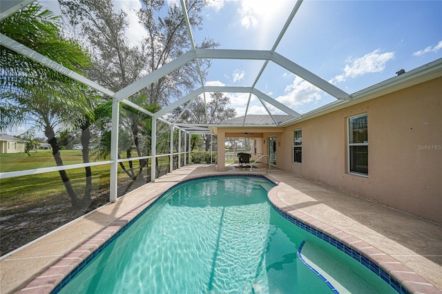 view of pool featuring a patio area and glass enclosure