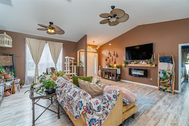 living room featuring hardwood / wood-style flooring, ceiling fan, and lofted ceiling