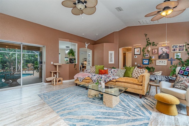 living room featuring lofted ceiling, wood-type flooring, and ceiling fan