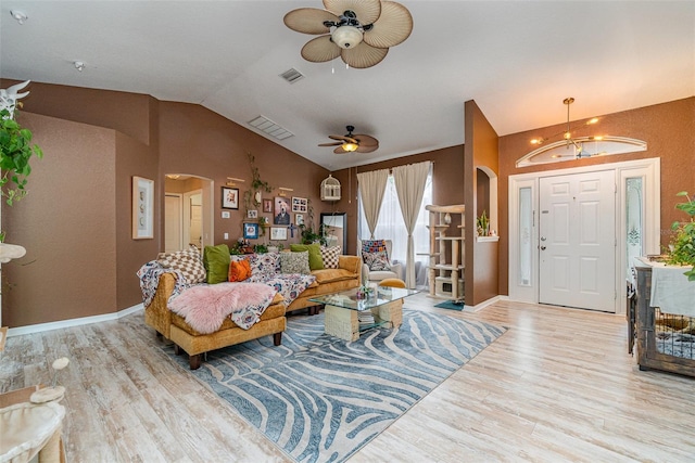 living room featuring light hardwood / wood-style flooring, lofted ceiling, and ceiling fan