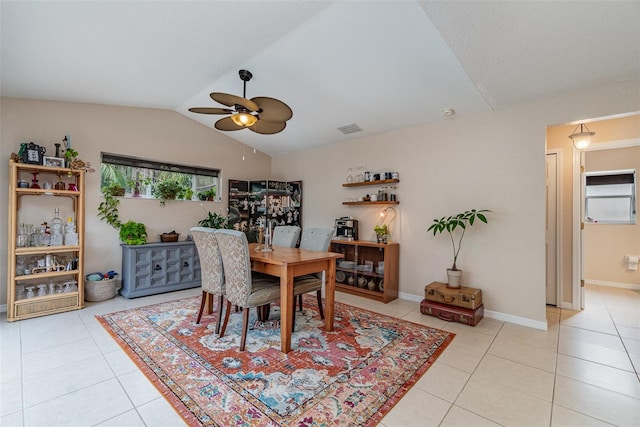 dining area featuring ceiling fan, plenty of natural light, light tile patterned floors, and lofted ceiling