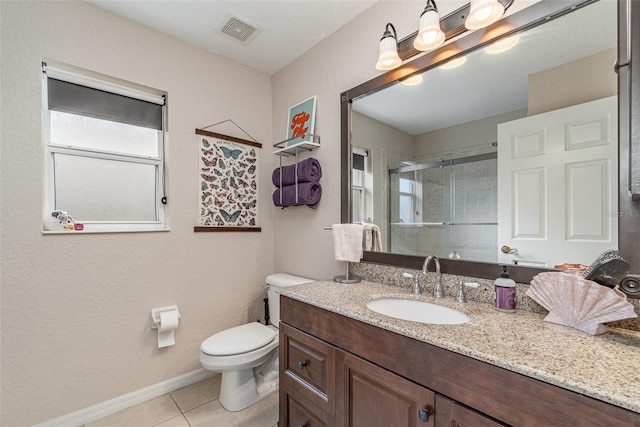 bathroom with vanity, a shower with door, tile patterned floors, and toilet