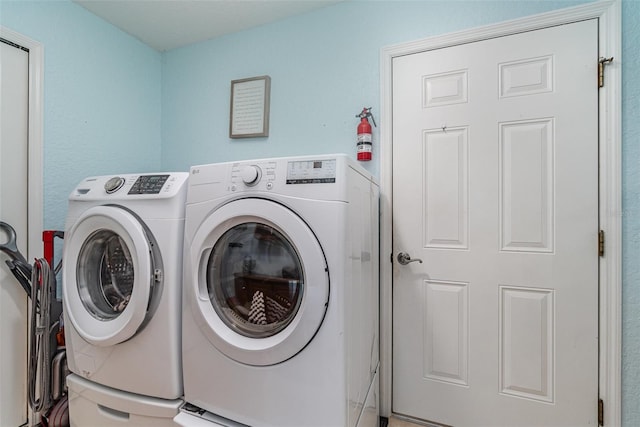 clothes washing area featuring washing machine and dryer