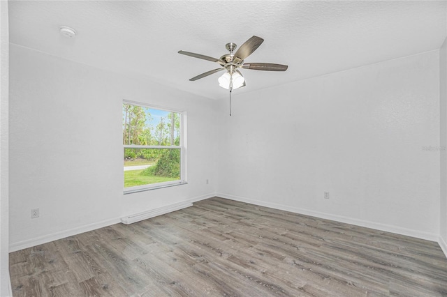 empty room with wood-type flooring and ceiling fan