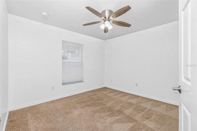 unfurnished room featuring ceiling fan and carpet floors