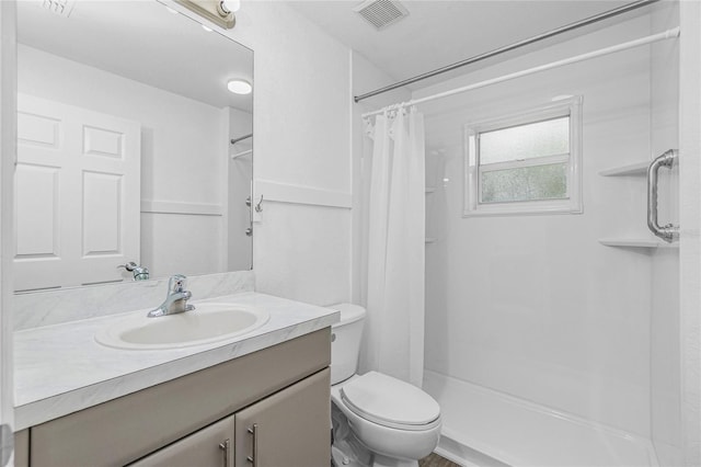 bathroom with vanity, toilet, and a shower with shower curtain