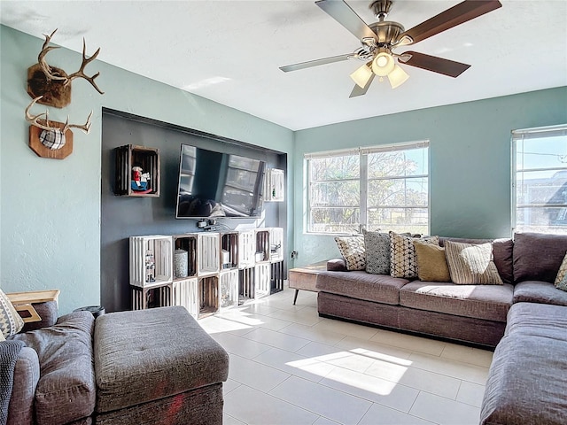 tiled living room featuring ceiling fan