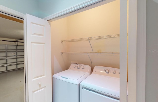 clothes washing area with washer and dryer