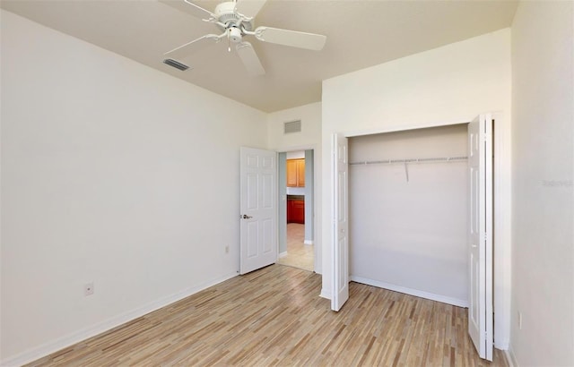 unfurnished bedroom with ceiling fan, a closet, and light hardwood / wood-style flooring