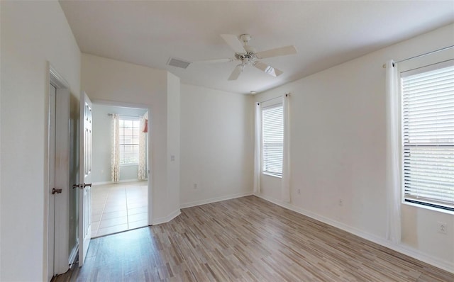 spare room with light hardwood / wood-style floors and ceiling fan