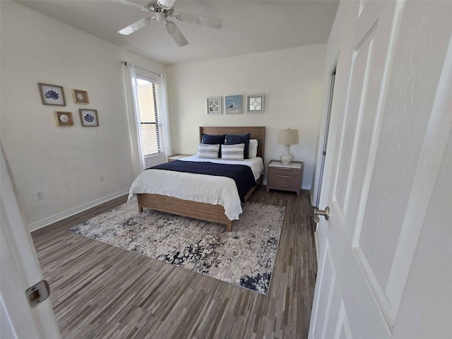 bedroom featuring wood finished floors, a ceiling fan, and baseboards