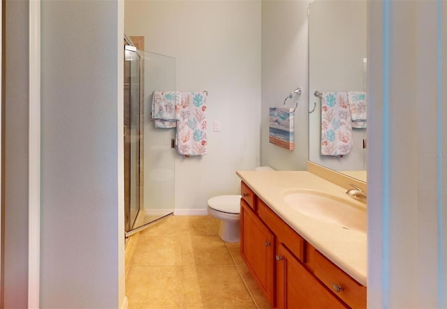 full bath featuring a shower stall, vanity, toilet, baseboards, and tile patterned flooring