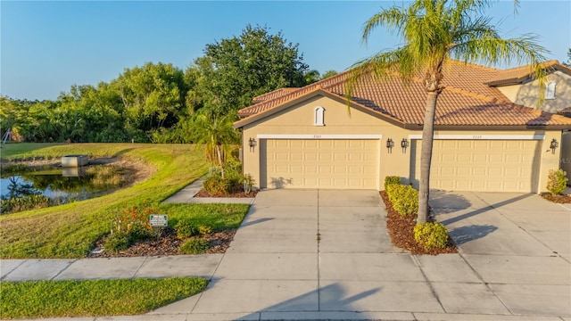 2765 Arugula Dr, North Port, FL 34289 - mediterranean / spanish-style home featuring stucco siding, a tile roof, concrete driveway, and a garage