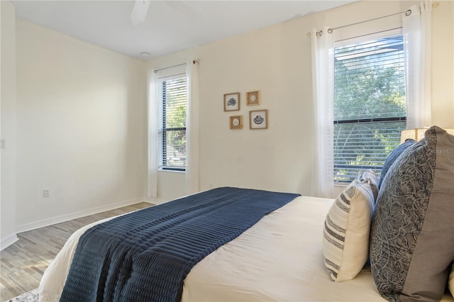 2765 Arugula Dr, North Port, FL 34289 - bedroom with wood finished floors, ceiling fan, and baseboards