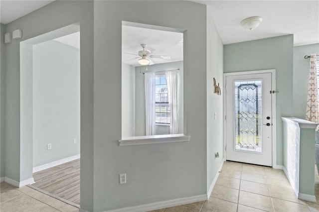 2765 Arugula Dr, North Port, FL 34289 - tiled foyer with baseboards and a ceiling fan