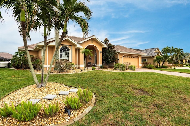 ranch-style house featuring a garage and a front yard