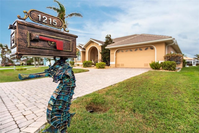 view of front of house with a front yard and a garage