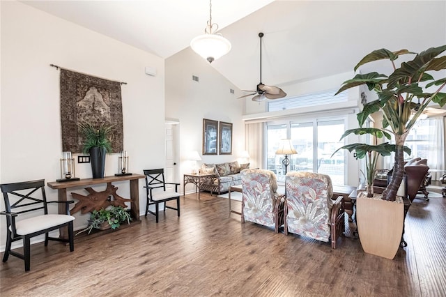 living room featuring high vaulted ceiling, dark hardwood / wood-style flooring, and plenty of natural light