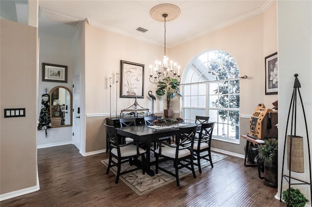 dining area with a chandelier, dark hardwood / wood-style floors, and crown molding