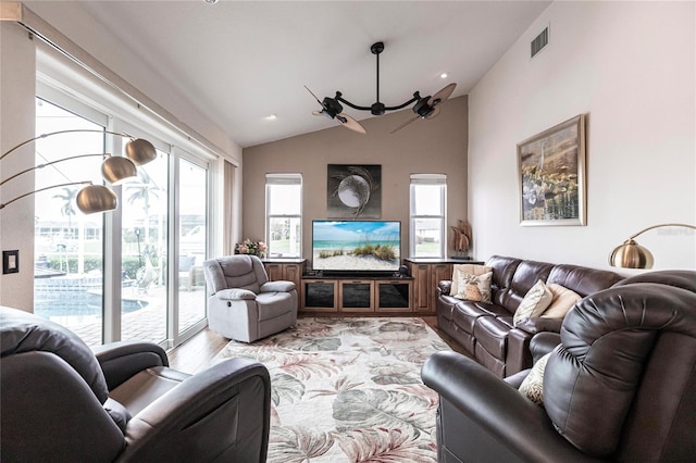 living room with light hardwood / wood-style floors, vaulted ceiling, and a notable chandelier