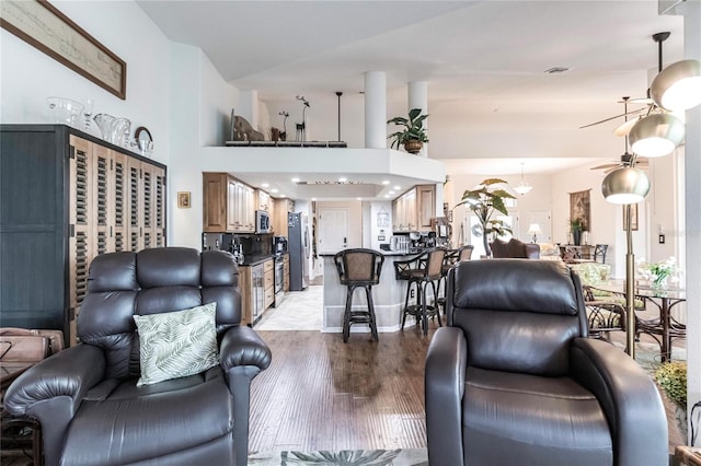 living room featuring light wood-type flooring and ceiling fan