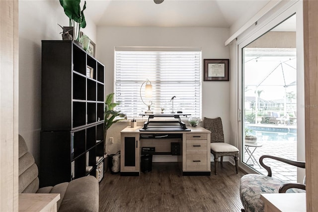 home office with dark hardwood / wood-style flooring and vaulted ceiling