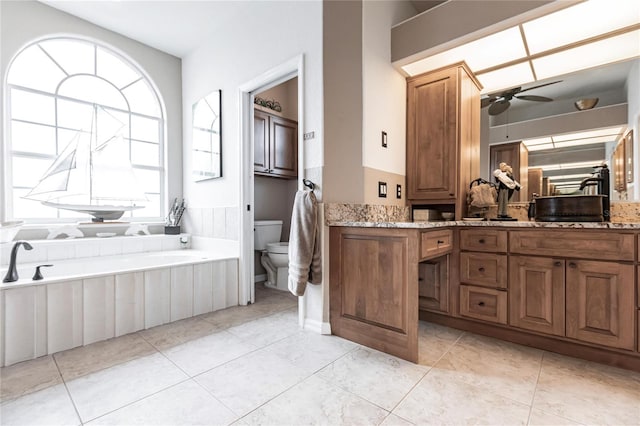 bathroom featuring vanity, ceiling fan, plenty of natural light, and toilet