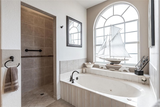 bathroom featuring shower with separate bathtub