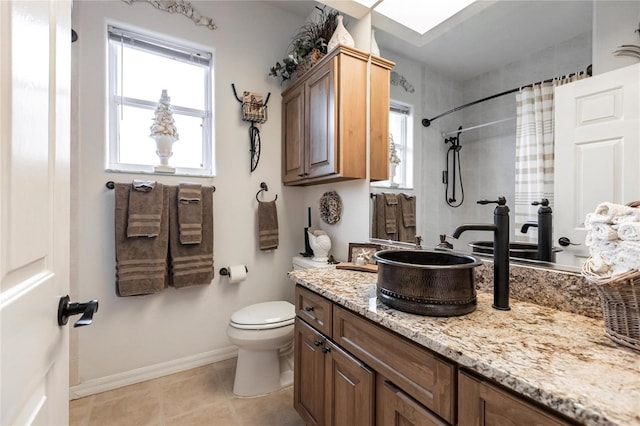 bathroom featuring vanity, curtained shower, tile patterned floors, and toilet