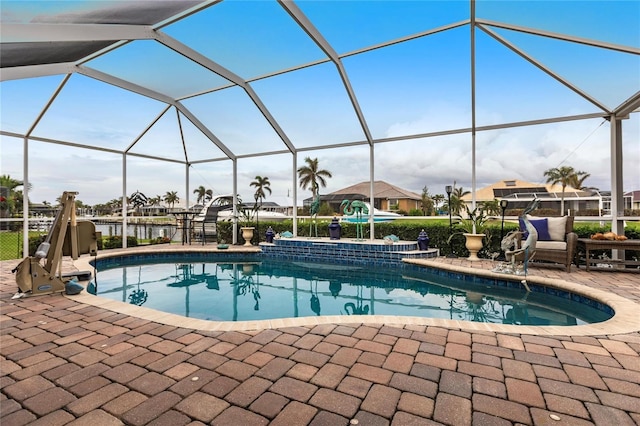 view of swimming pool with glass enclosure and a patio