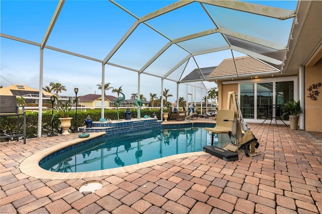 view of pool with a lanai and a patio