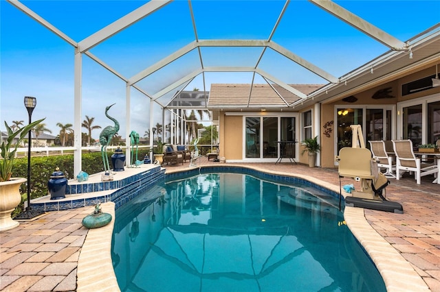 view of swimming pool with a patio and glass enclosure