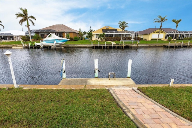 view of dock featuring a lawn, glass enclosure, and a water view