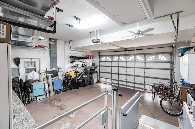 garage featuring electric panel, a garage door opener, and ceiling fan