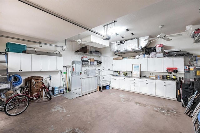 garage with a garage door opener, water heater, and ceiling fan