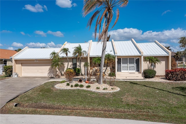 view of front of property with a front lawn and a garage