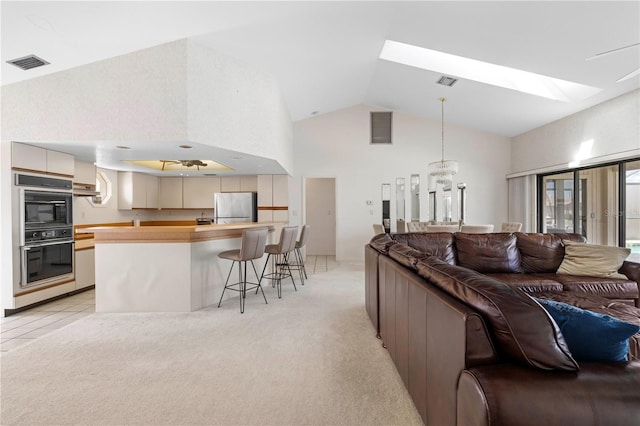 carpeted living room with vaulted ceiling