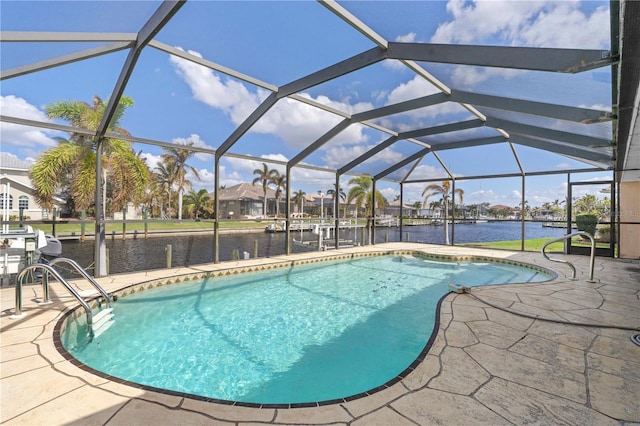 view of pool featuring a patio area, a water view, and glass enclosure