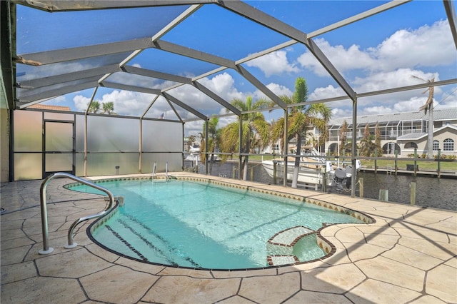 view of pool featuring a patio area, a lanai, and a water view