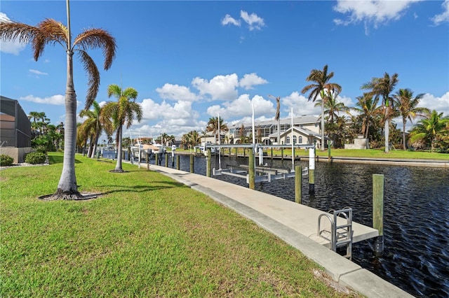 view of dock with glass enclosure, a water view, and a lawn