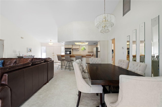 dining space with a notable chandelier and high vaulted ceiling